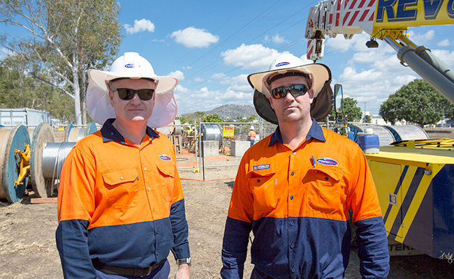 Two staff members wearing protective clothing