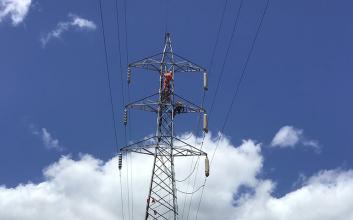 Worker on transmission tower
