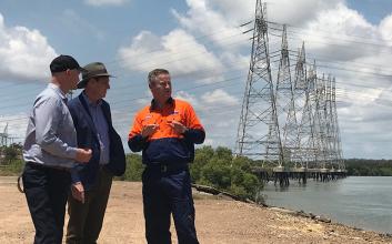 Member for Gladstone Glenn Butcher, Energy Minister Dr Anthony Lynham and Powerlink's Gerard Reilly in front of the 'dolphin structures on the Calliope River