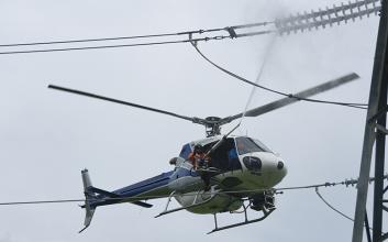 Helicopter spraying insulators