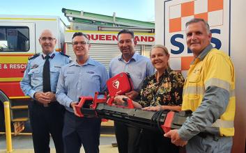 SES partnership representatives holding new equipment