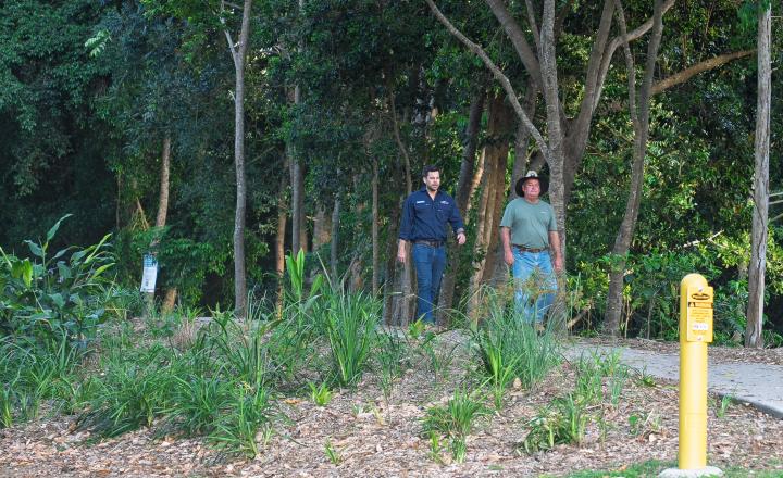 Two people walking along a path