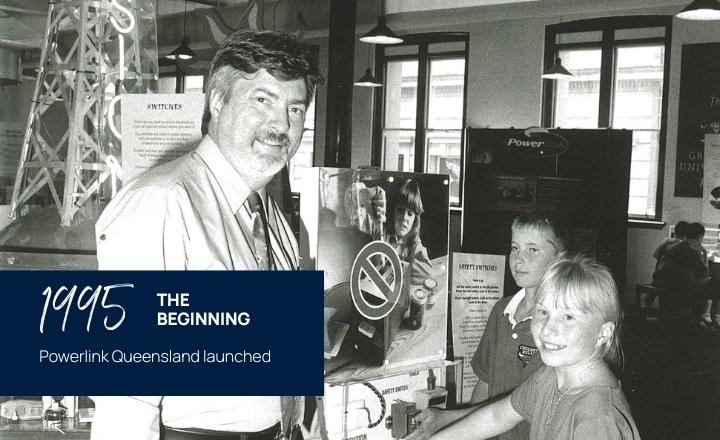 Powerlink employee and children looking at transmission display in 1995
