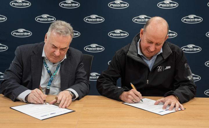 two men signing a contract