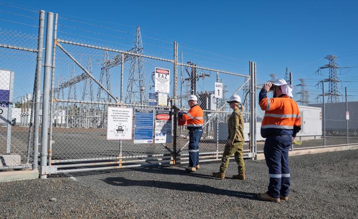 people outside gate near substation