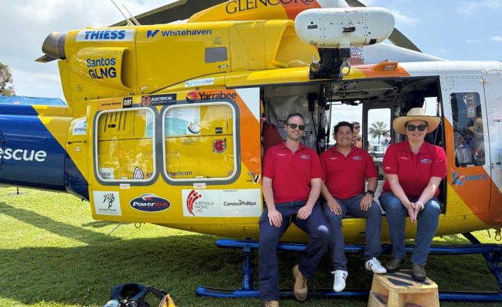 three people sitting in helicopter